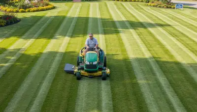Commercial mower creating striped lawn patterns by Chop Chop Landscaping in Bloomington, IN